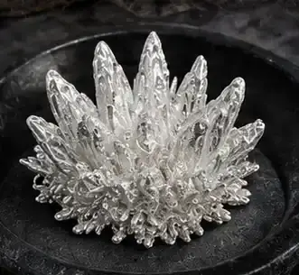 Pure silver crystals are harvested from the cell.